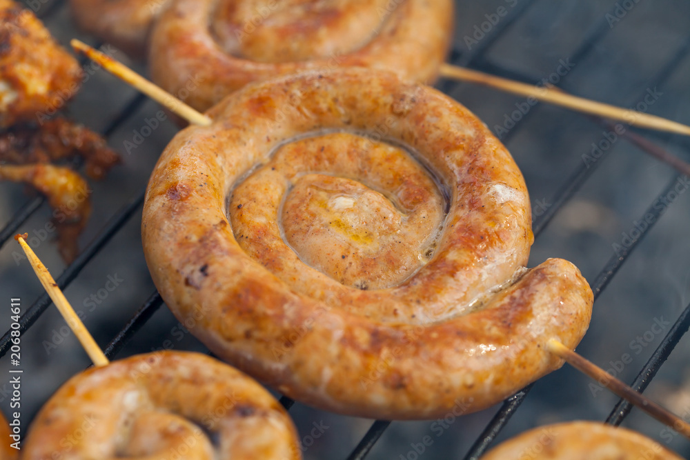 Spiral pork sausage on barbeque grill Spiral pork sausage on barbeque grill