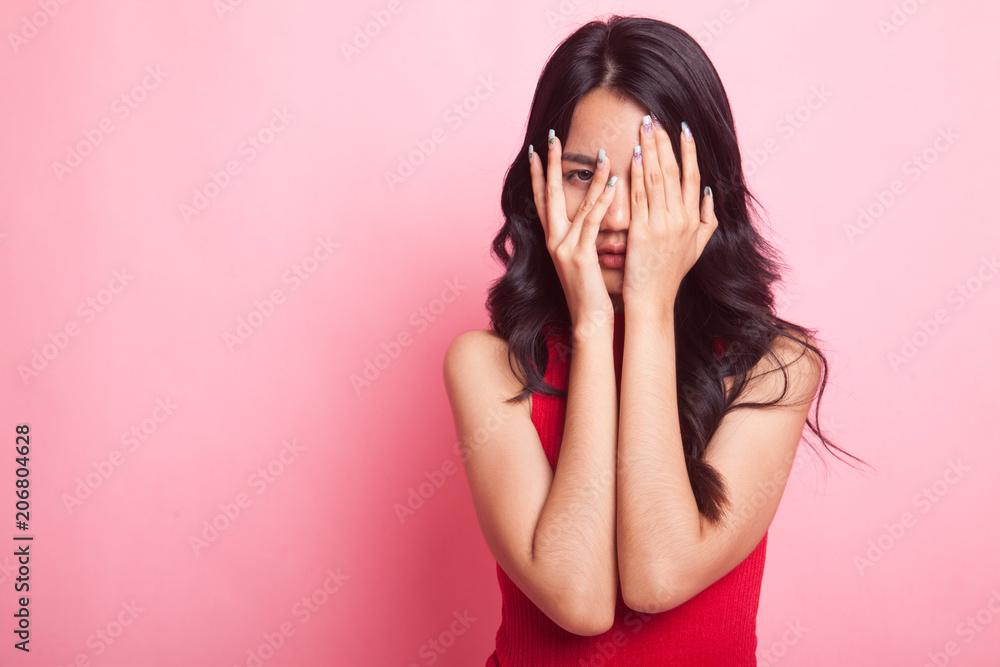 Beautiful young Asian woman peeking through fingers. Beautiful young Asian woman peeking through fingers.