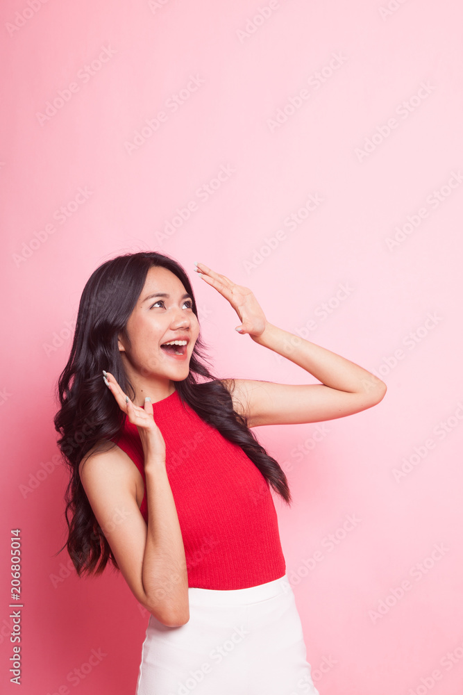 Excited young Asian woman look up. Excited young Asian woman look up.