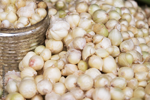 close-up of small onions and a tin