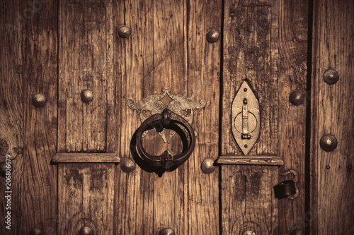 Wooden door with old metal lock. Image in old color style