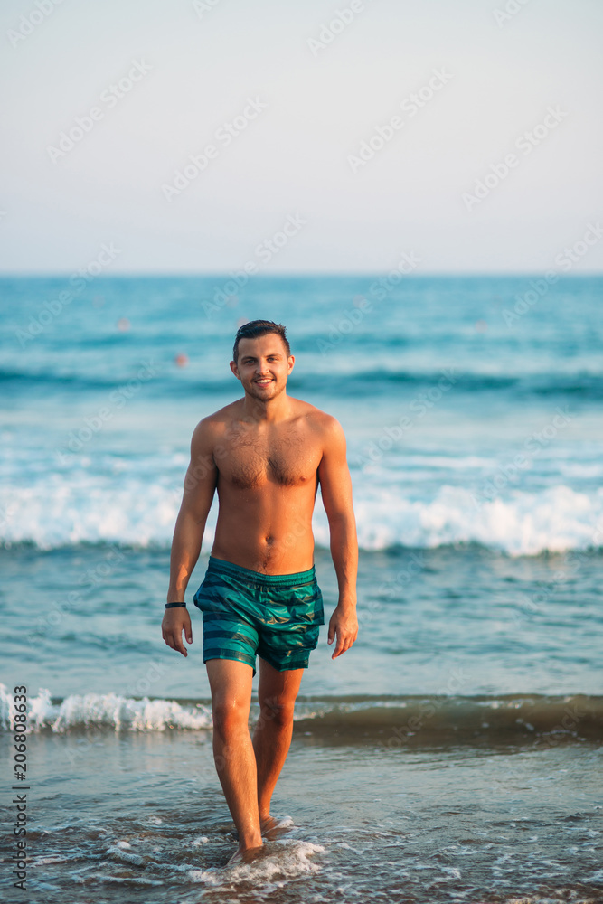 Portrait of an attractive young man on a tropical beach