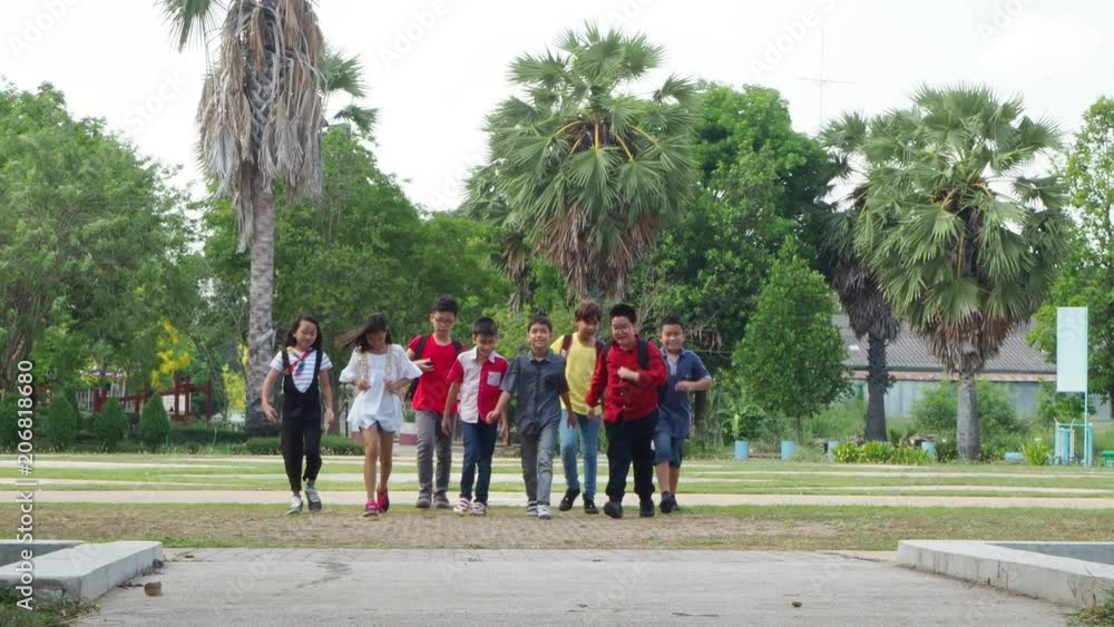 Group of young asian student running in school park Group of young asian student running in school park