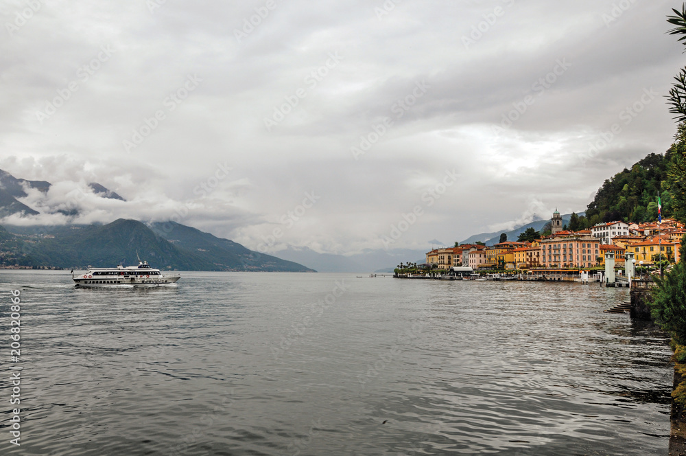 View of Lake Como in cloudy day with the buildings of Bellagio, a charming tourist village between the lake and the mountains of the Alps. Located in the Lombardy region, northern Italy