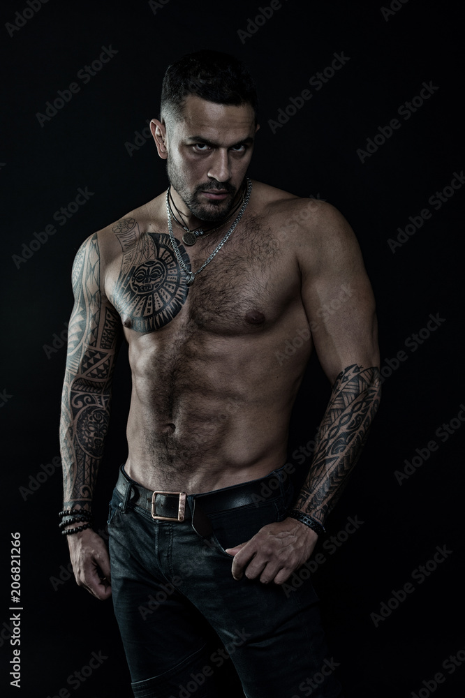 Tattoo model with six pack and ab. Bearded man with tattooed body. Man with sexy bare