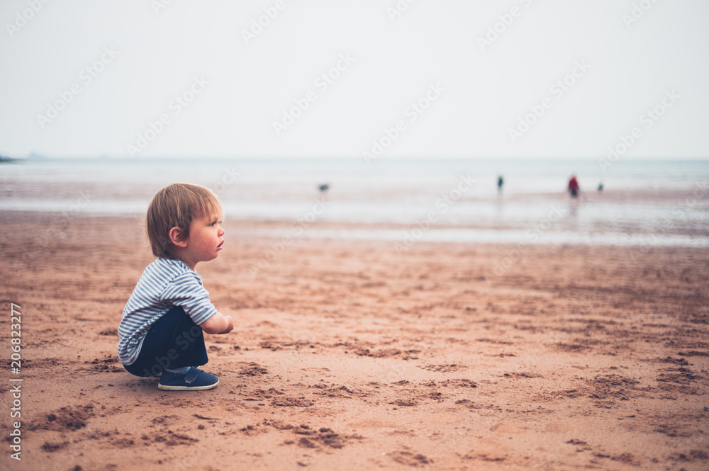 Little toddler boy sititng on beach Little toddler boy sititng on beach