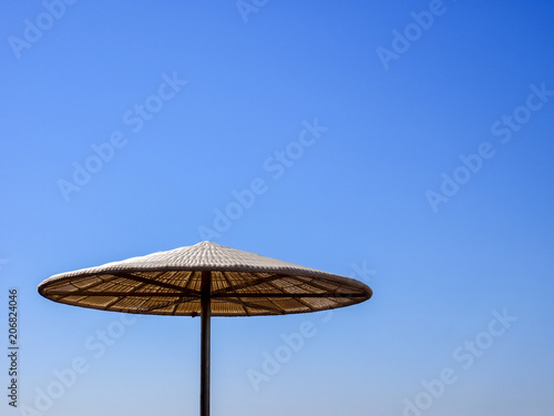 Sunshade on sunny summer day  tropical background.