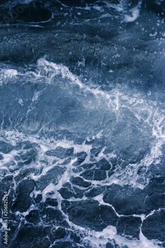 Abstract blue background white veins, ocean wave, bubble and foam at high tide and surf, pattern