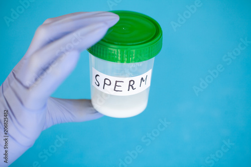 Health. Sperm Analysis. Concept of Bank Sperm. Infertility. Doctor's Hand Holding Container for Analyzes. photo