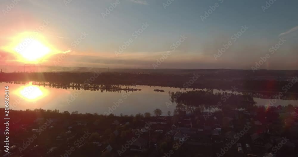Aerial view of village and lake at sunset. 4K Aerial view of village and lake at sunset. 4K