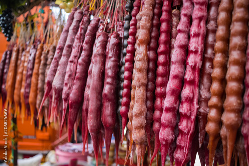 Churchkhela. Traditional Georgian homemade sweets with hazelnuts, walnuts, grape juice, honey (sugar), wheat flour (corn flour). Dessert sold in local food market in Georgia, Tbilisi or Batumi.