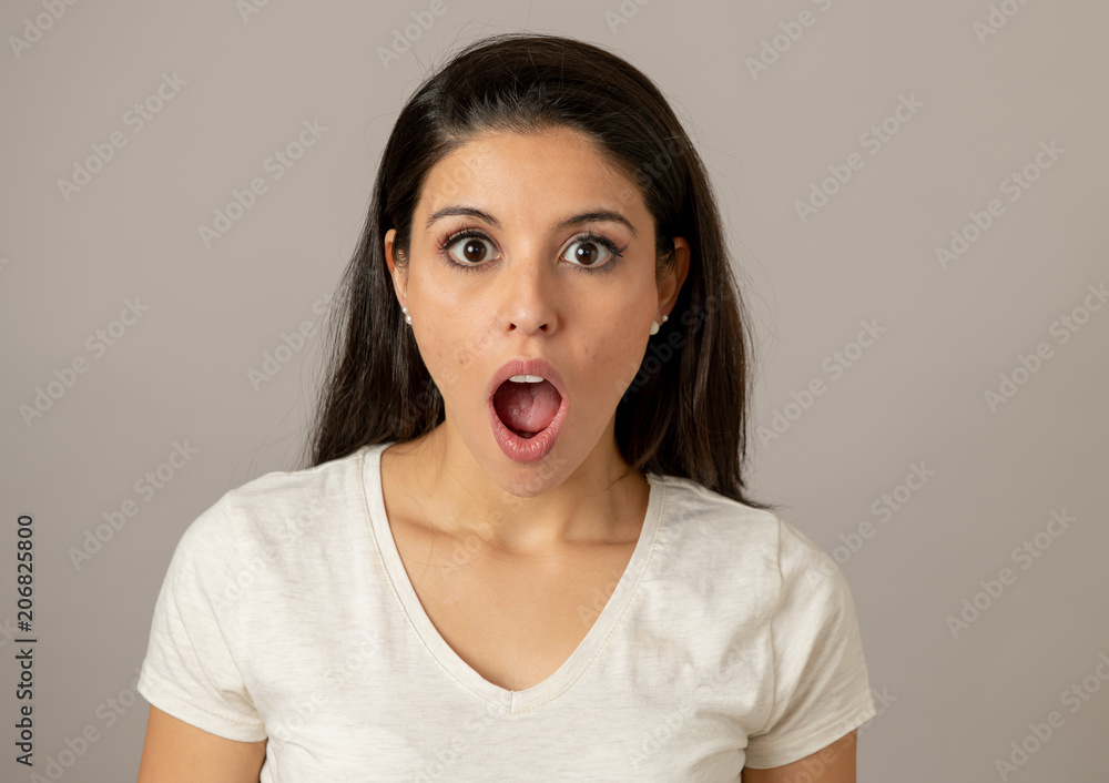 Young attractive woman with a surprised and shocked face, eyes and mouth wide open. Young attractive woman with a surprised and shocked face, eyes and mouth wide open.