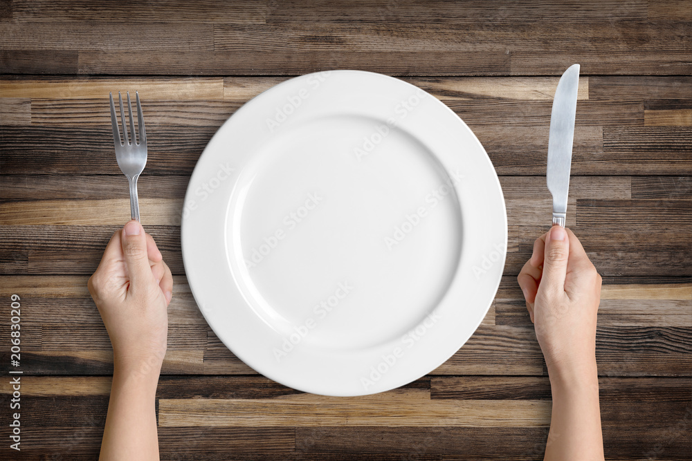 Fotografie White plate with silver fork and spoon with clipping path