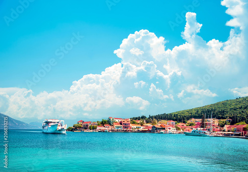 Beautiful scenic landscape with bay and ferry on the background of magical clouds in Nydri, Lefkada, Greece. Stunning amazing charming places. prominent tourist towns.