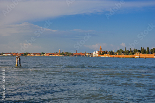 Panoramic view of Venice lagoon with buildings on the horizon, at the sunset in the city center of Venice, the historic and amazing marine city. Located in the Veneto region, northern Italy