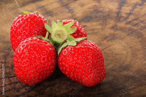 heap of strawberry on woodedn background photo