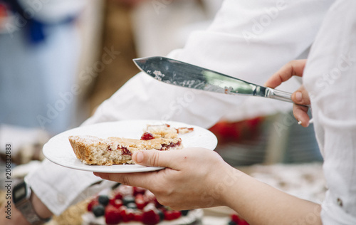 hand holding plates of cake