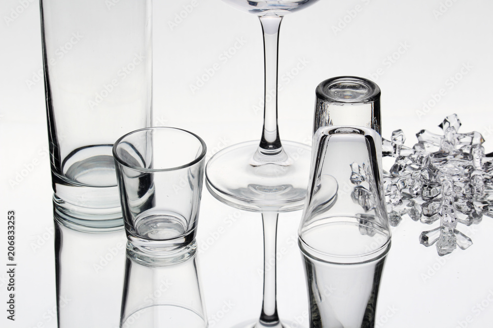 Different empty glasses against white background Different empty glasses against white background
