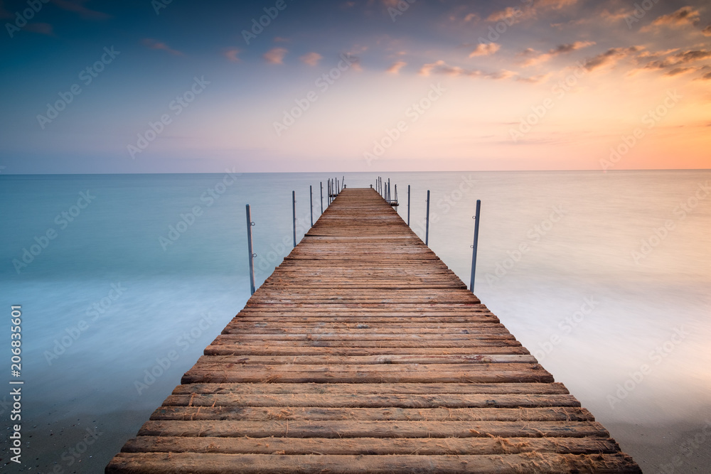 sunset pier wit clouds in the sea of minimalism