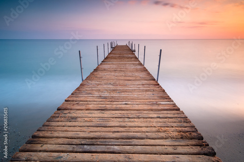 Fototapeta Naklejka Na Ścianę i Meble -  sunset pier in the sea of minimalism