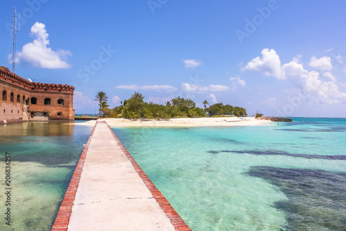 The tropical waters of the Gulf of Mexico surround Historic Fort Jefferson in the Dry Tortugas National Park known for its famous bird  marine life and great place for swimming and snorkeling.