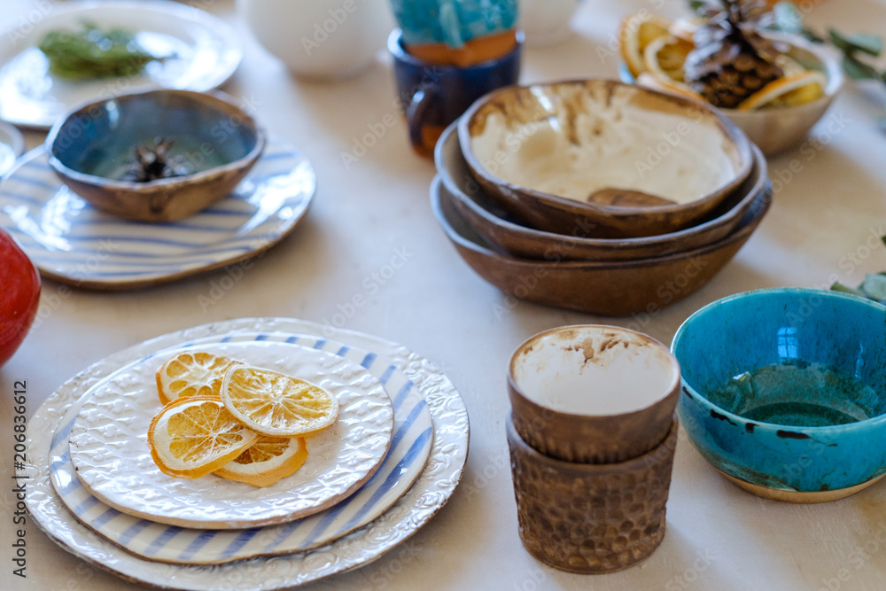 handmade crockery. handicraft pottery. artisan clay plates bowls cups and  mugs assortment Stock Photo | Adobe Stock