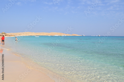 azure coast with white sand, clean and clear blue water on a sunny day