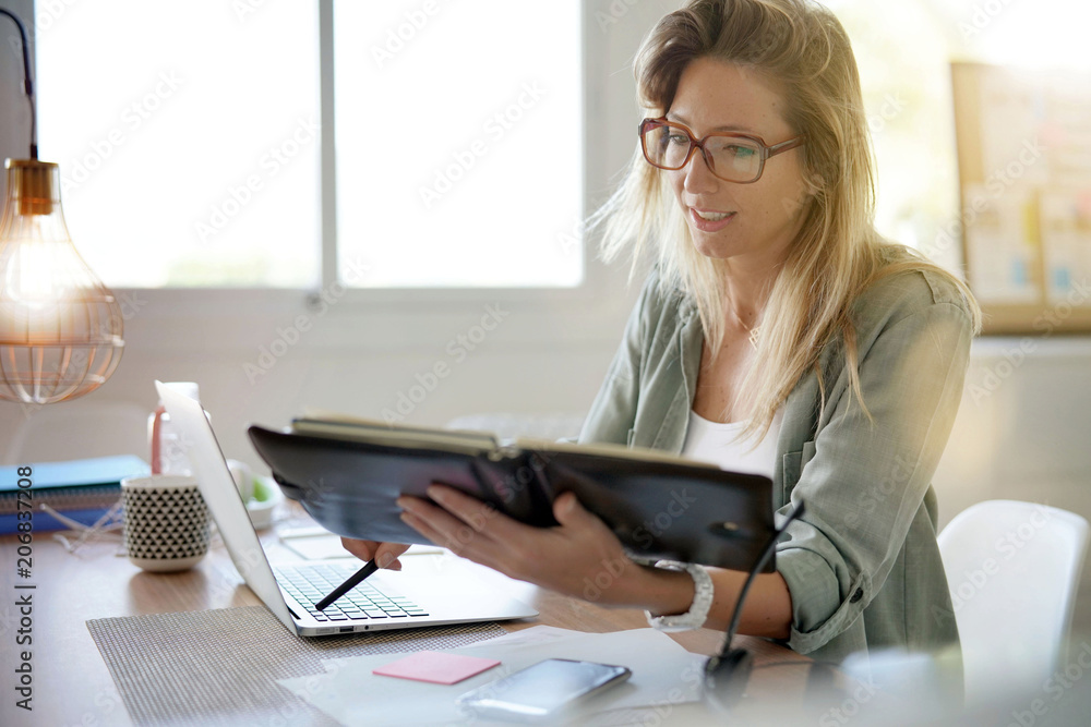 Woman working in office on laptop computer Woman working in office on laptop computer