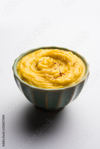 Amrakhand OR Mango Shrikhand / srikhand is popular Indian dessert served with saffron toppings in a bowl