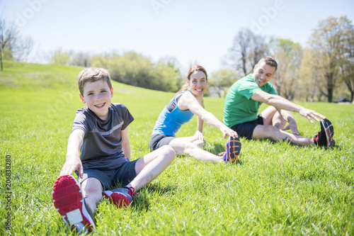 Parents with children sstretching together outside