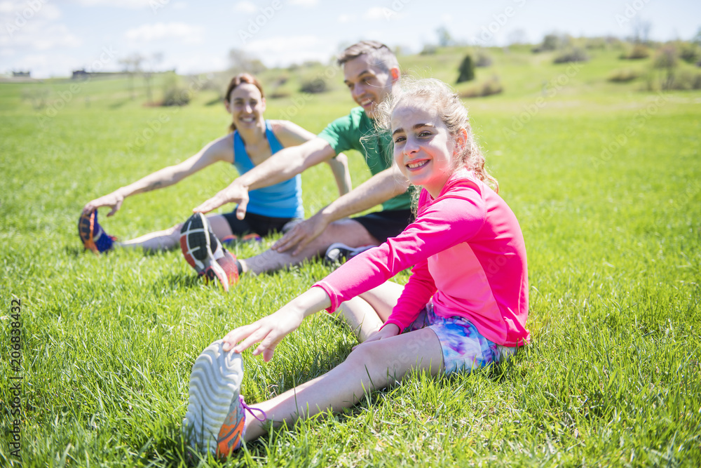 Fototapeta premium Parents with children sport running together outside