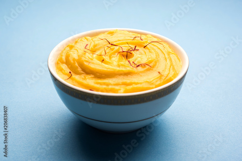 Amrakhand OR Mango Shrikhand / srikhand is popular Indian dessert served with saffron toppings in a bowl