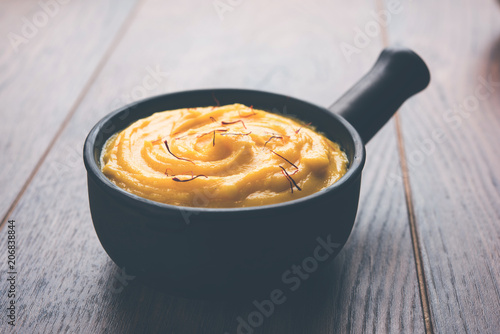 Amrakhand OR Mango Shrikhand / srikhand is popular Indian dessert served with saffron toppings in a bowl photo