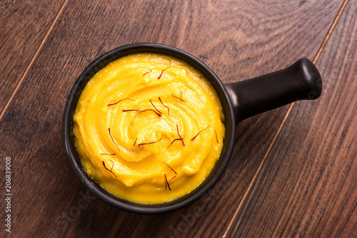 Amrakhand OR Mango Shrikhand / srikhand is popular Indian dessert served with saffron toppings in a bowl photo