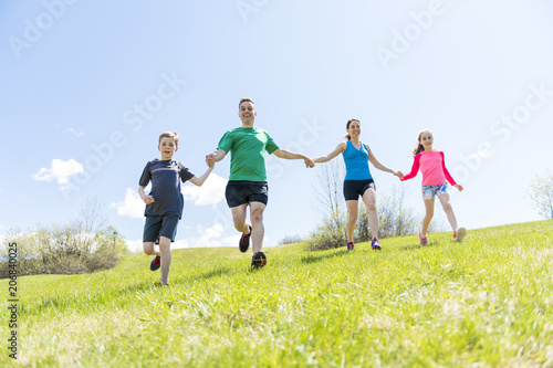 Parents with children sport running together outside