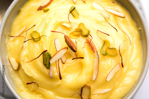 Shrikhand OR Srikhand is an Indian dessert made of strained yogurt, garnished with dry fruits and saffron. photo