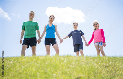 Parents with children sport running together outside