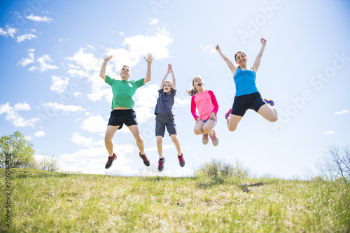 Parents with children sport running together outside