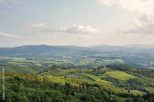 Panoramic view of fields, hills and trees at sunset in the Tuscan countryside, a gorgeous and traditional region in the center of the Italian Peninsula. Tuscany region