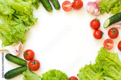 Healthy fresh vegetables for salad. Raw green lettuce, greens, tomato over white countertop. Top view. Copy space. Clean eating, vegan. Food concept. © svetlana_cherruty