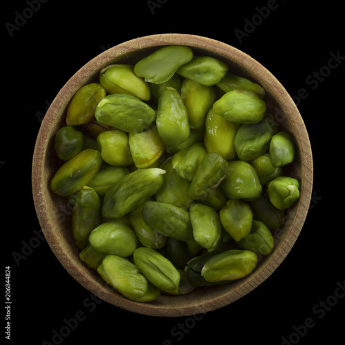 Wallpaper Mural shelled green pistachio in wooden cup isolated on black background. top view Torontodigital.ca