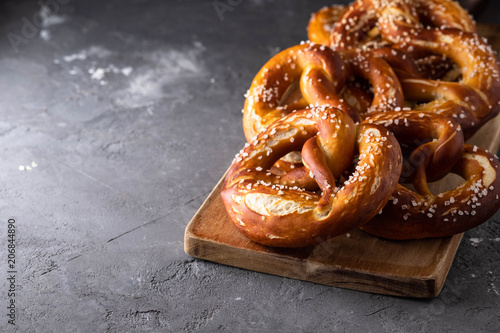 Freshly baked homemade soft pretzel with salt on rustic table. Perfect for Octoberfest. 