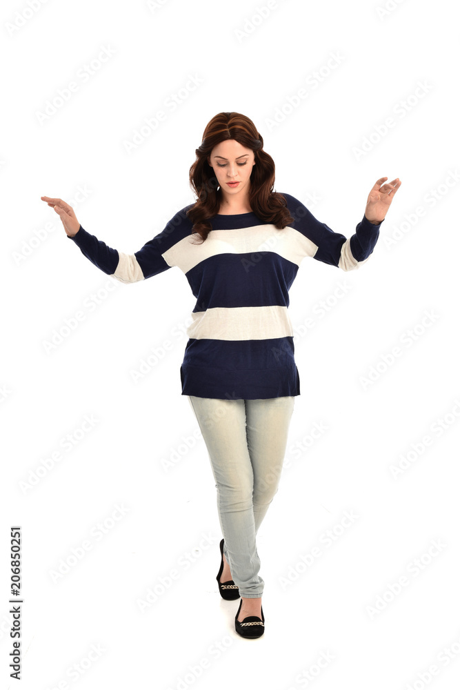 full length portrait of girl wearing striped blue and white jumper and jeans. standing pose on white studio background full length portrait of girl wearing striped blue and white jumper and jeans. standing pose on white studio background