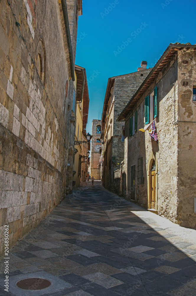 View of narrow alley with old buildings and belfry in Colle di Val d Elsa. A graceful village with its historic center preserved and known by its crystal production. Located in the Tuscany region 