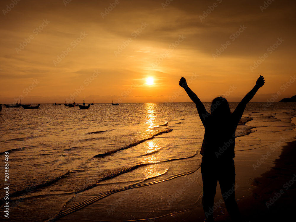 Girl cheerful background sunset at the sea