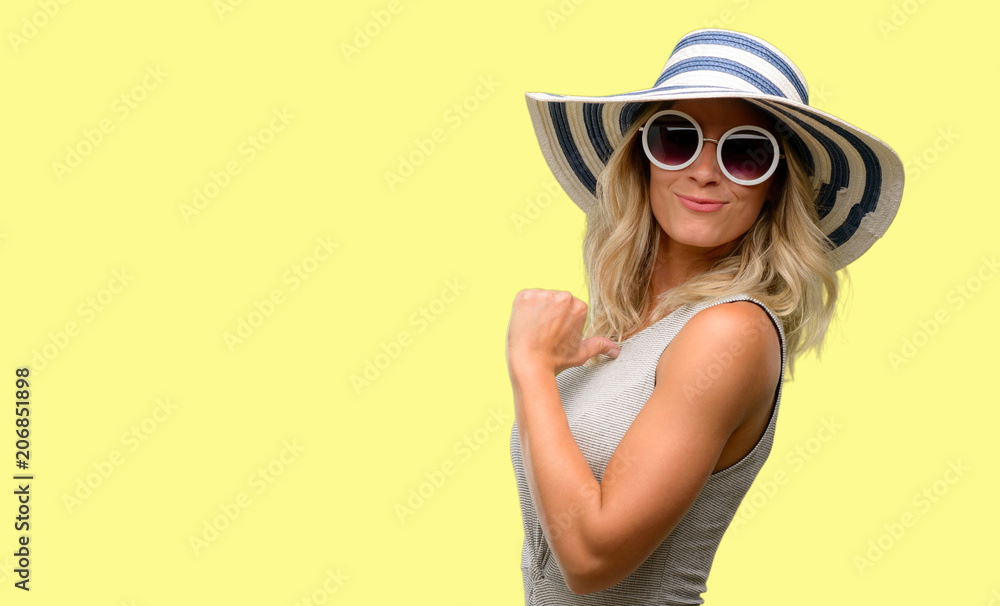 Young woman wearing sunglasses and summer hat proud, excited and arrogant, pointing with victory face Young woman wearing sunglasses and summer hat proud, excited and arrogant, pointing with victory face