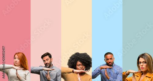 Cool group of people  woman and man serious making a time out gesture with hands