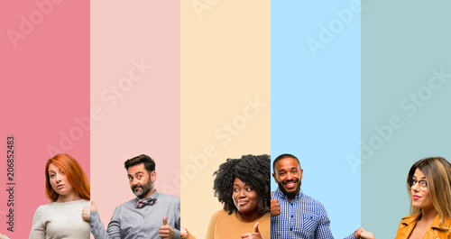 Cool group of people, woman and man thumb up holding something in empty hand and making ok gesture