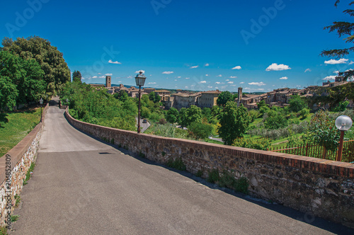 View of Colle di Val d Elsa town with bridge and vegetation at the front. A graceful village with its historic center preserved and known by its crystal production. Located in the Tuscany region  photo