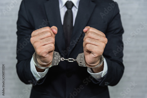 Fotografie businessman in handcuffs arrested isolated on gray background